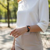 Bakers Bands Limited black Milanese loop band with folding buckle for Apple Watch, made of stainless steel.