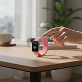 Bakers Bands Limited bright guava nylon woven sport loop band for Apple Watch on a wooden desk with a hand touching it.