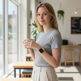 Bakers Bands Limited cantaloupe nylon sport loop band on a woman wearing a grey t-shirt in a bright cafe setting